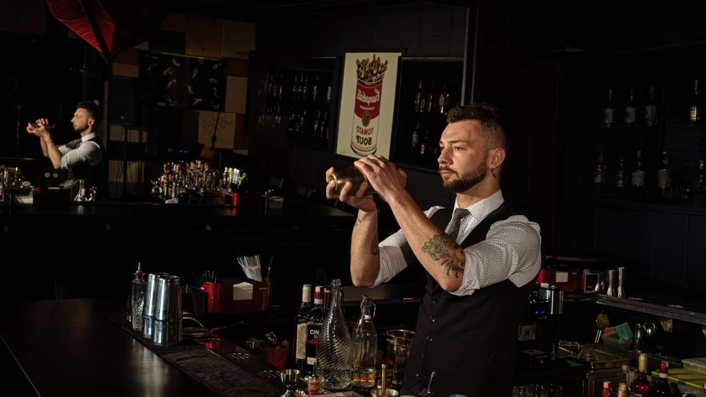 The Boobar test kitchen — copper jiggers, glassware, and a butcher-block bar in a Brooklyn loft.